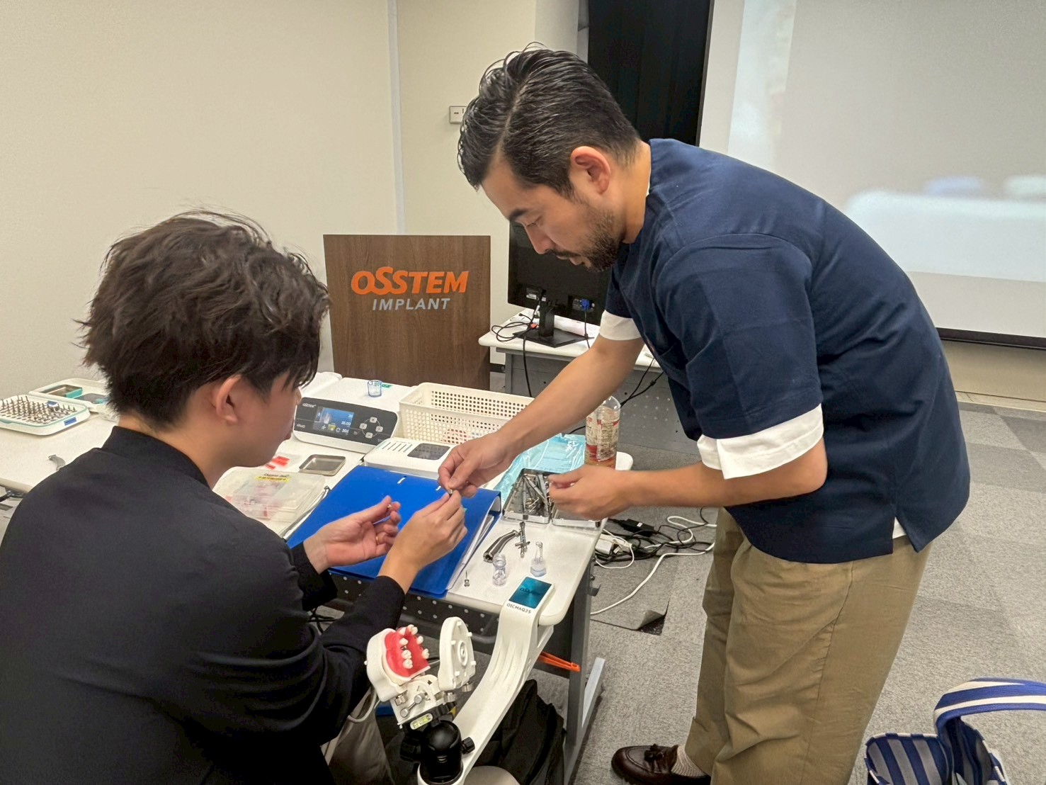 OSSTEM MASTER COURSEで受講者にインプラント実習の手順を説明する橋口隼人